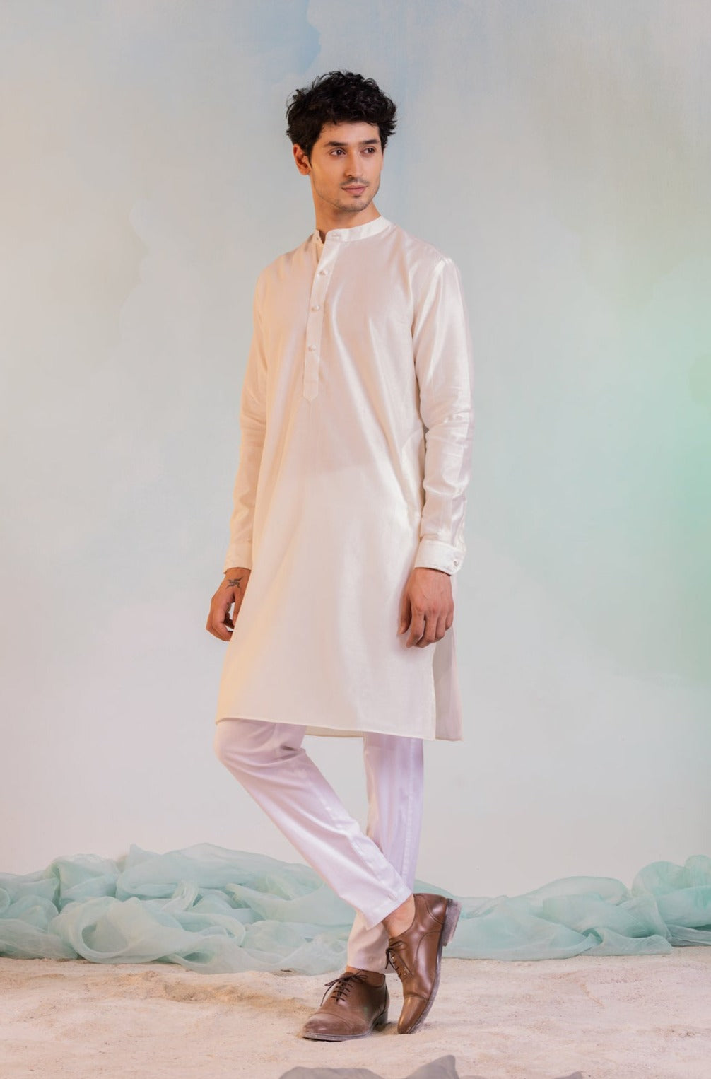Off white asymmetrical bandi paired with off white asymmetrical kurta